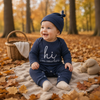 CuddleBaby – Hi, I'm new here – Baby Jumpsuit met Beanie Set